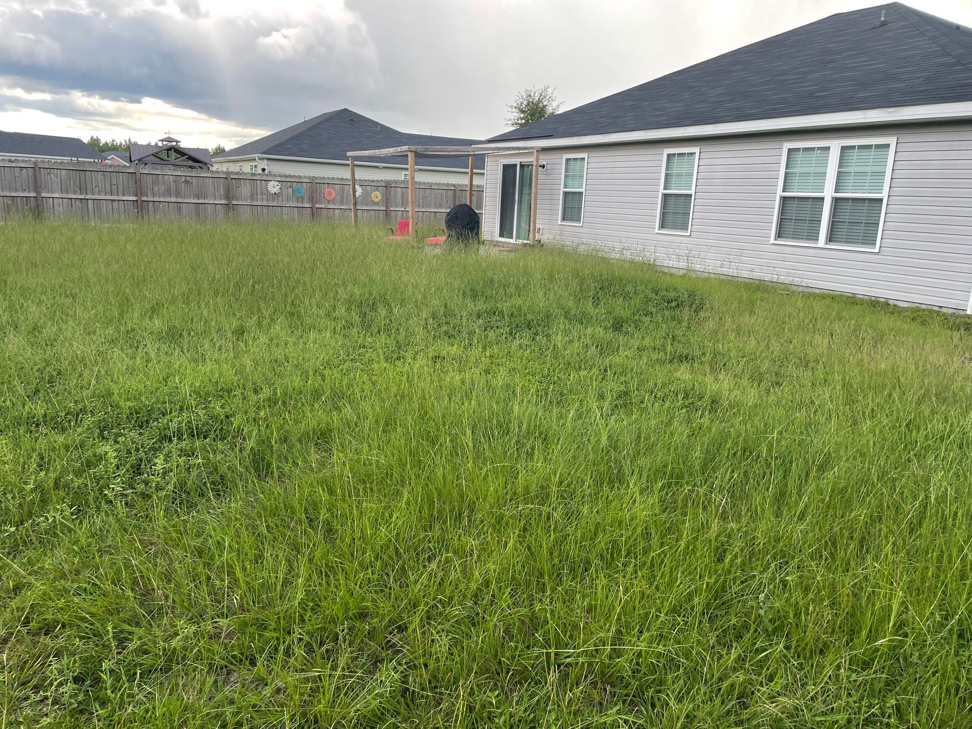 A house with a lot of grass in front of it.