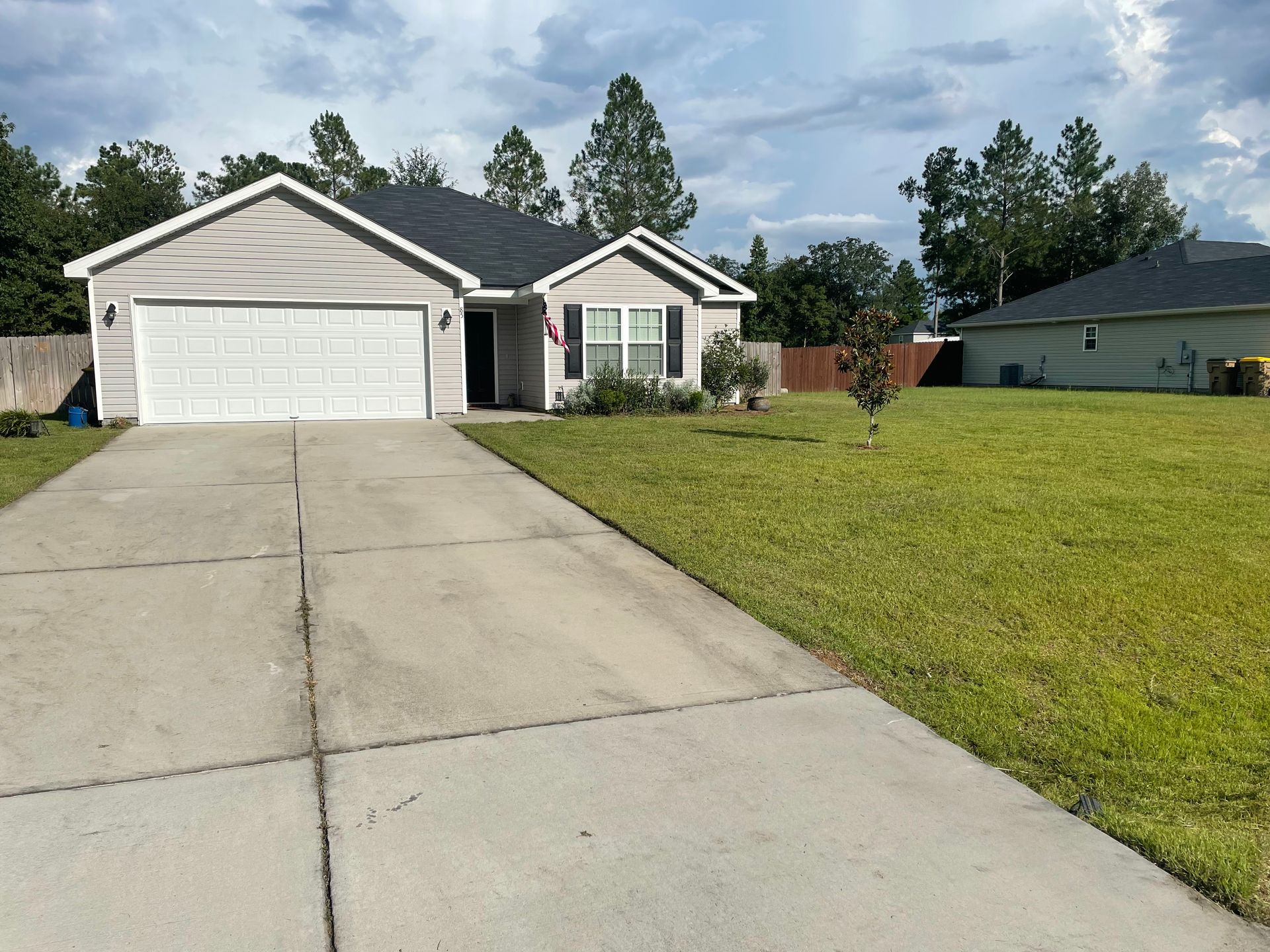 A house with a concrete driveway leading to it