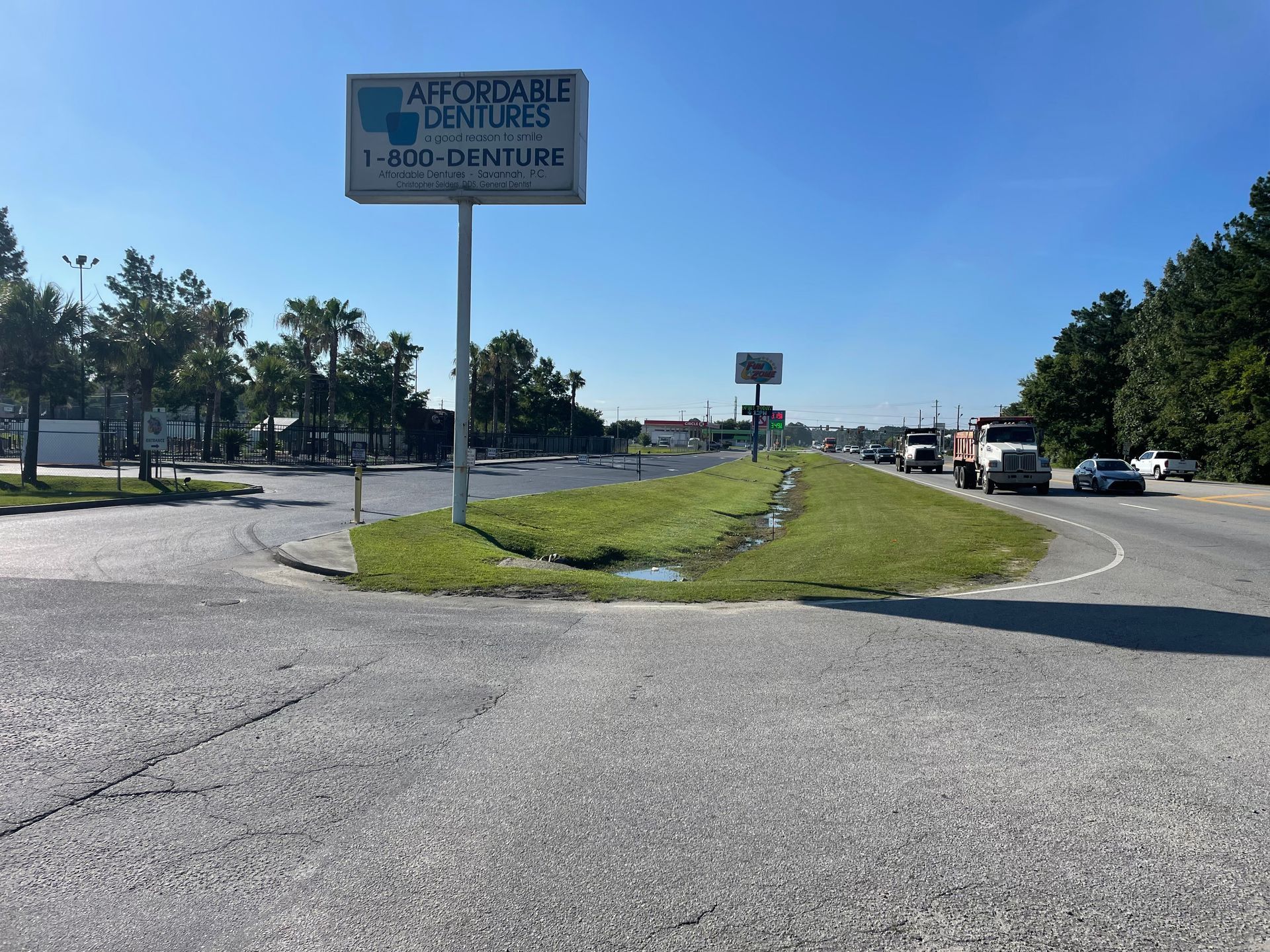 A large billboard is sitting on the side of a road.