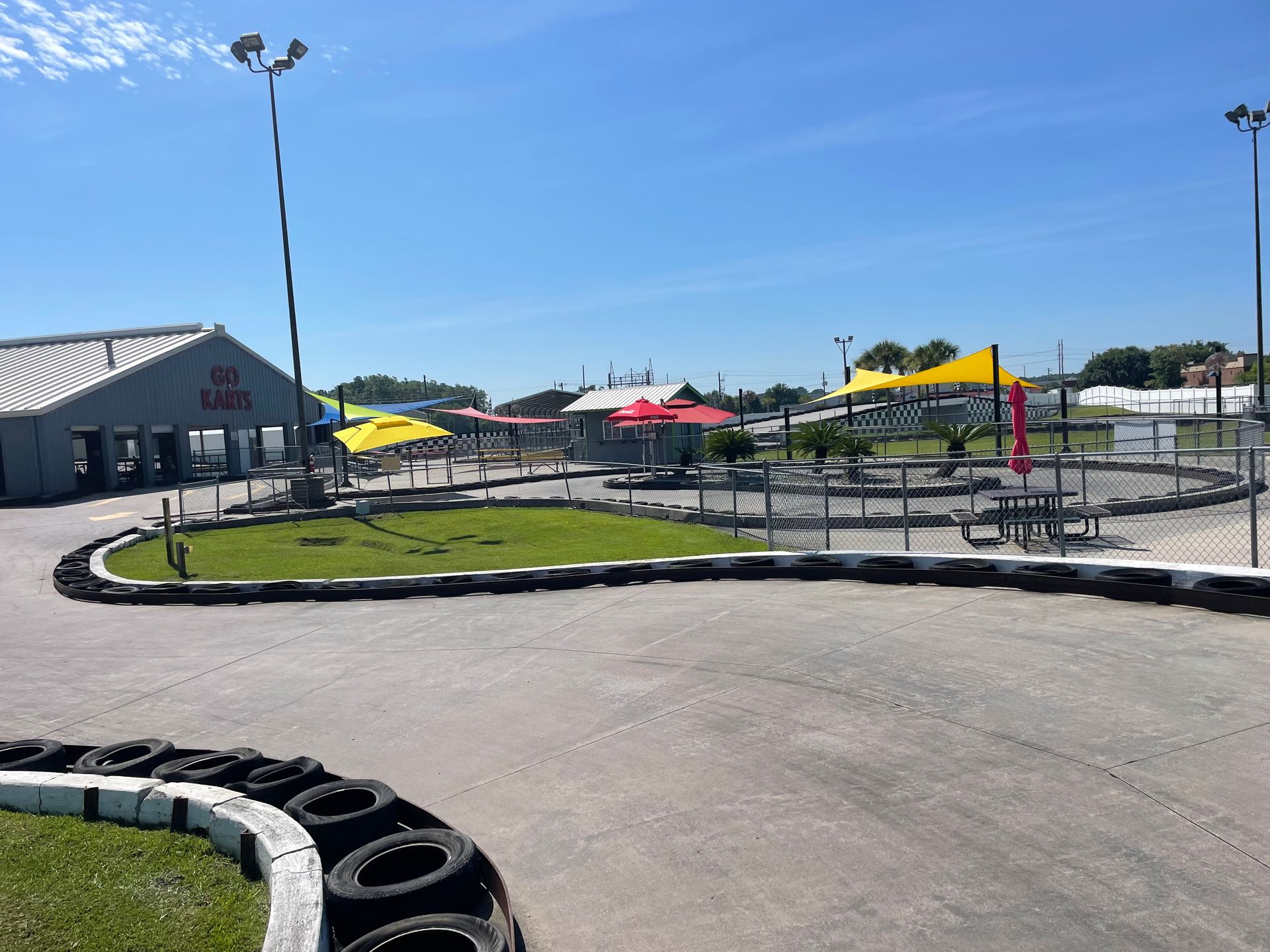 A go kart track with a building in the background.
