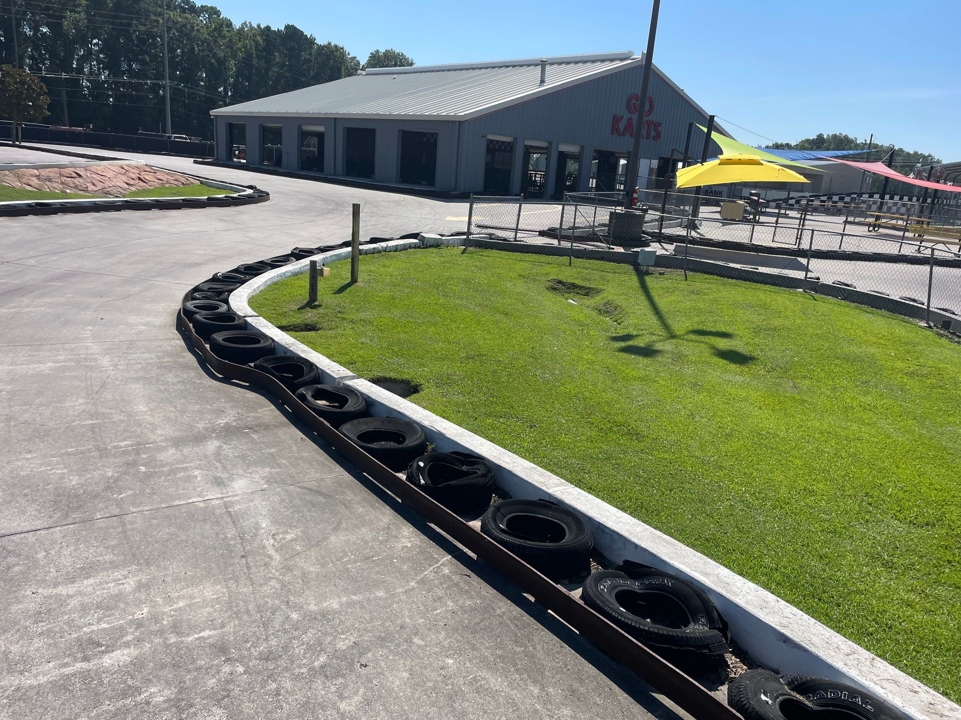 A go kart track with a building in the background