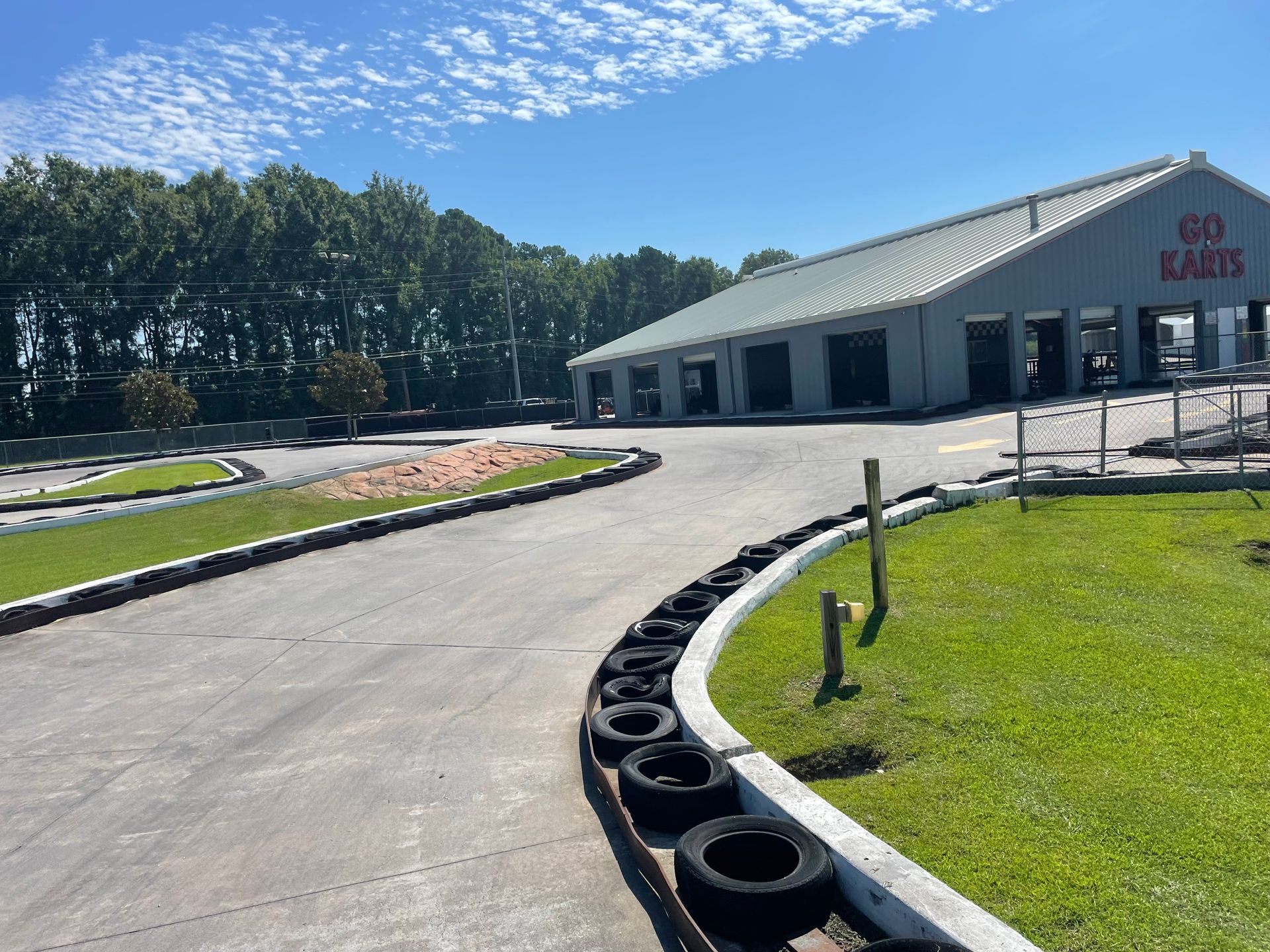 A go kart track with a building in the background that says go karts