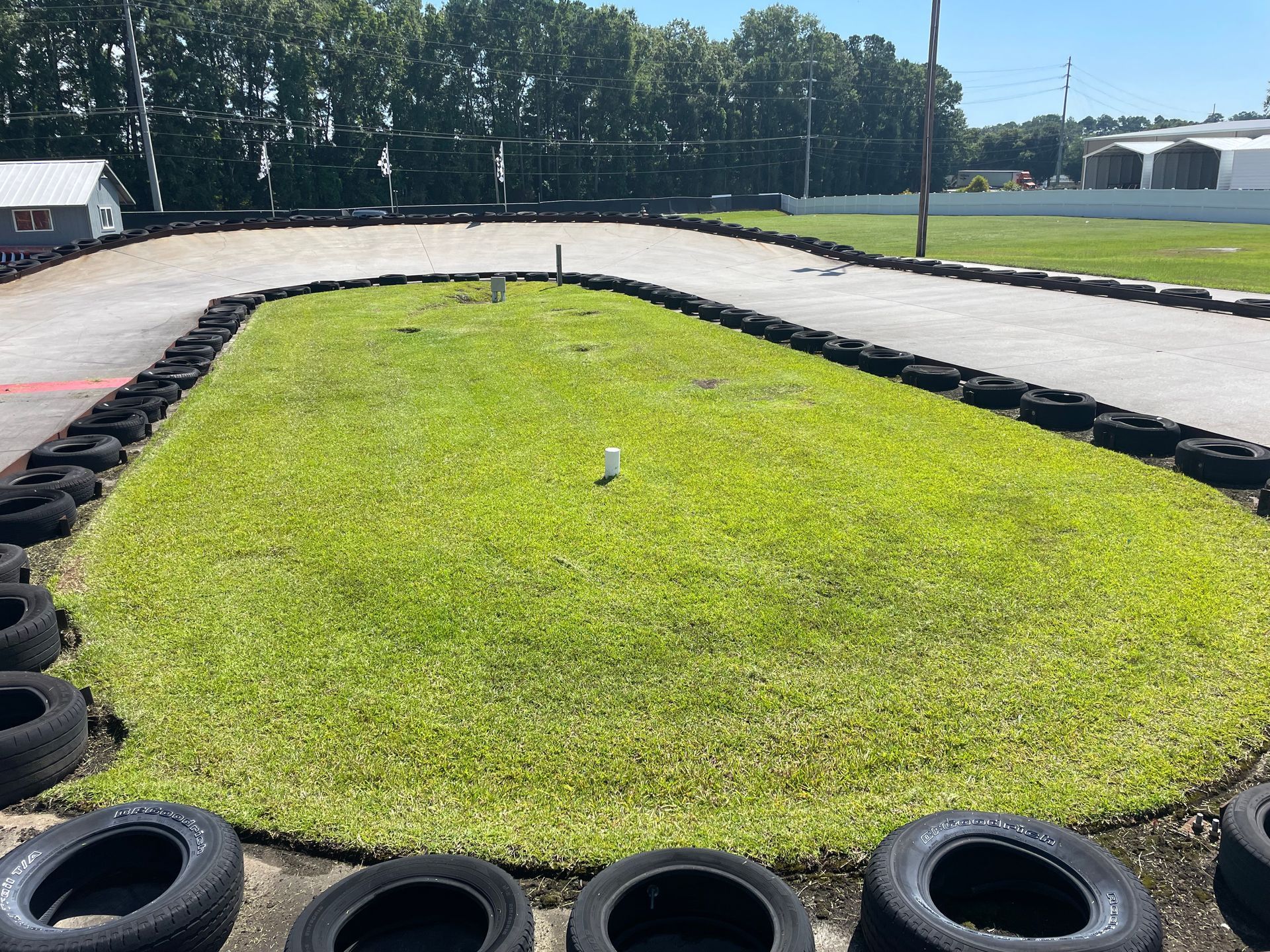 A go kart track with tires on the side of it.