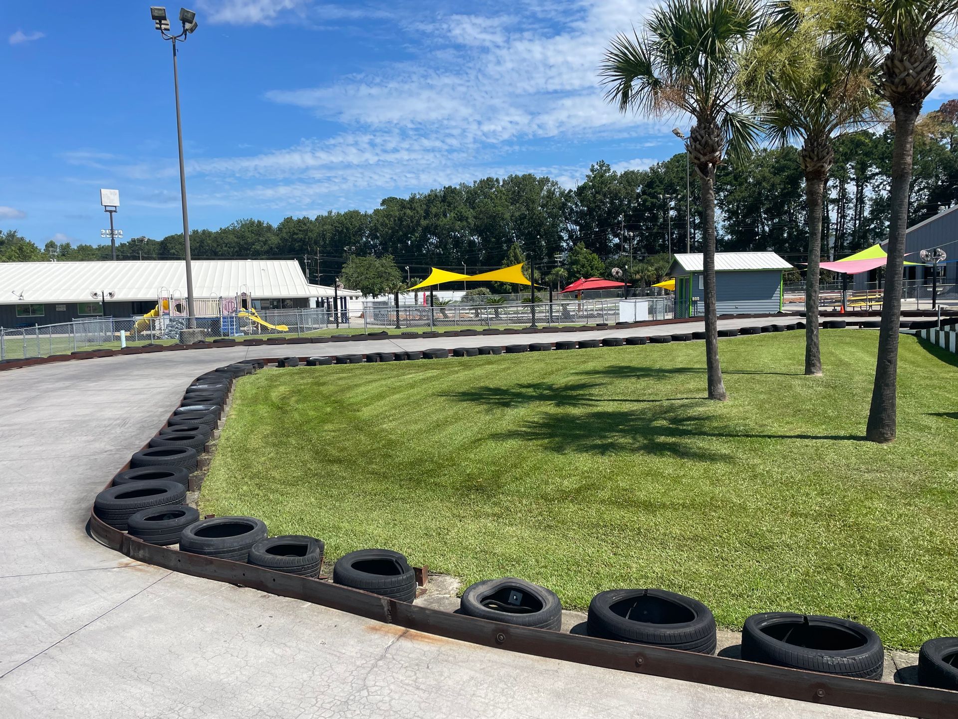 A go kart track with tires on the side of it.