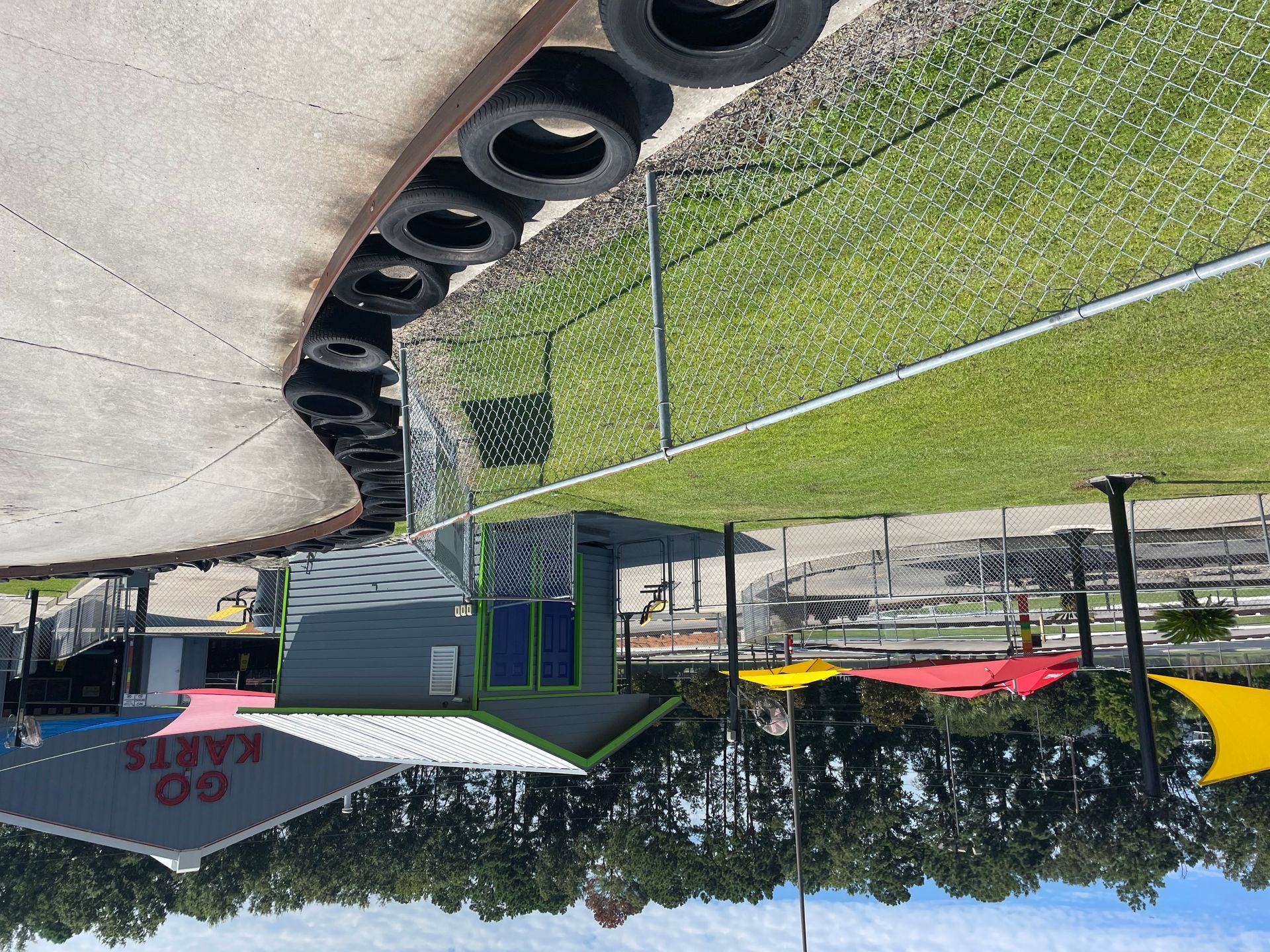 A sign that says go karts is on the side of the road