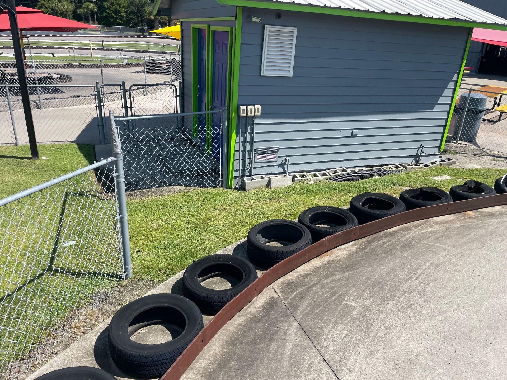 A row of tires are lined up on the side of a road.