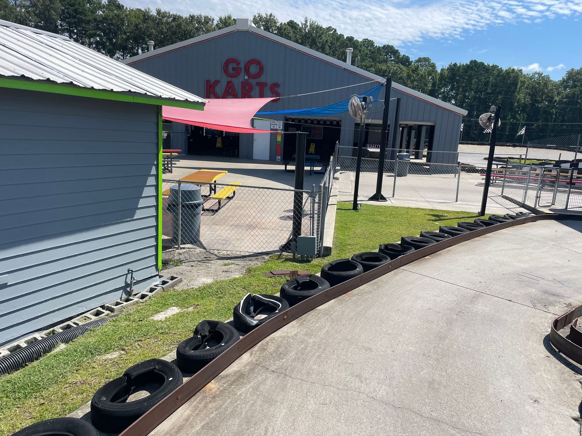A go kart track with a building in the background.