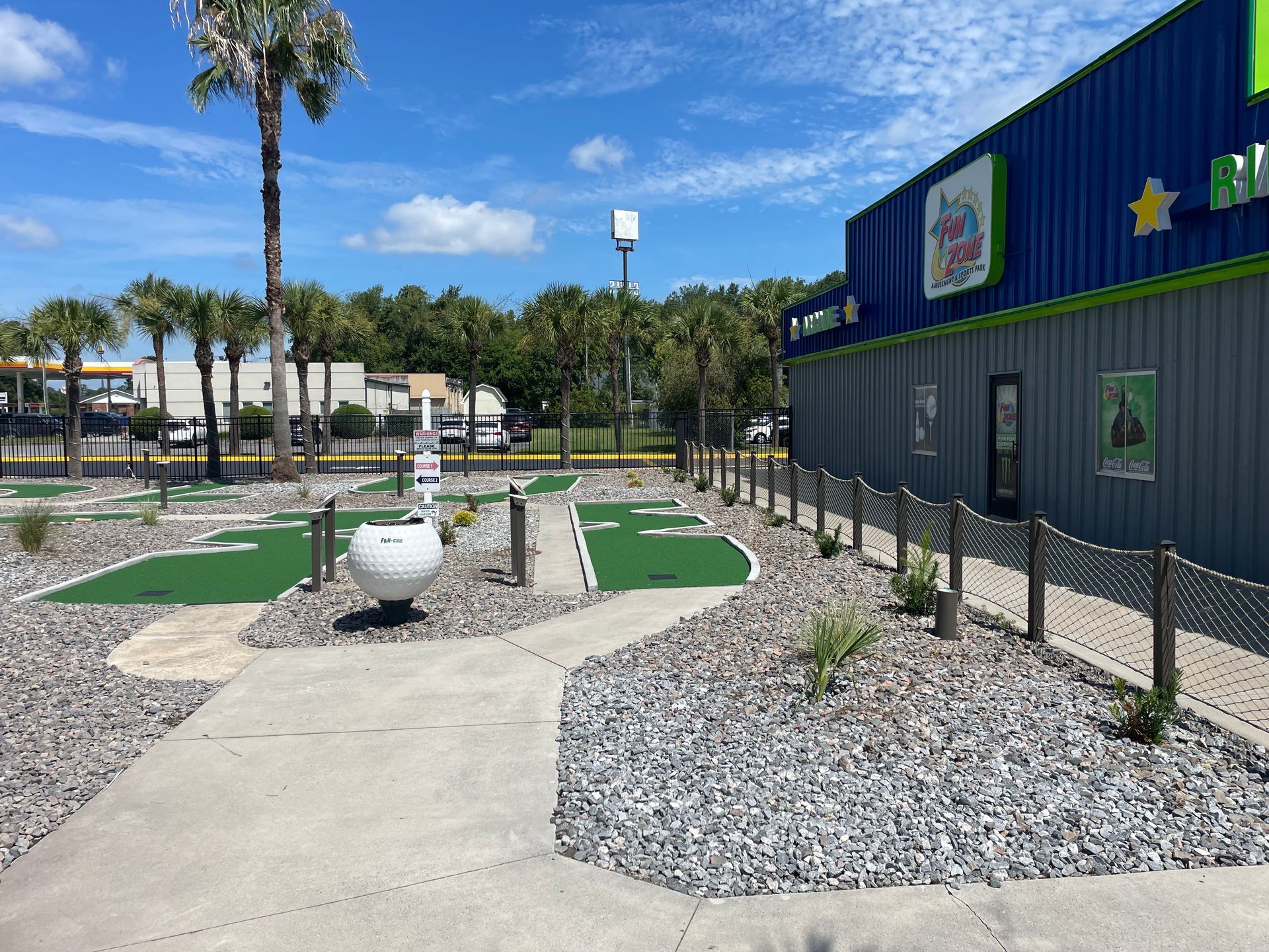 A mini golf course is located in front of a building.
