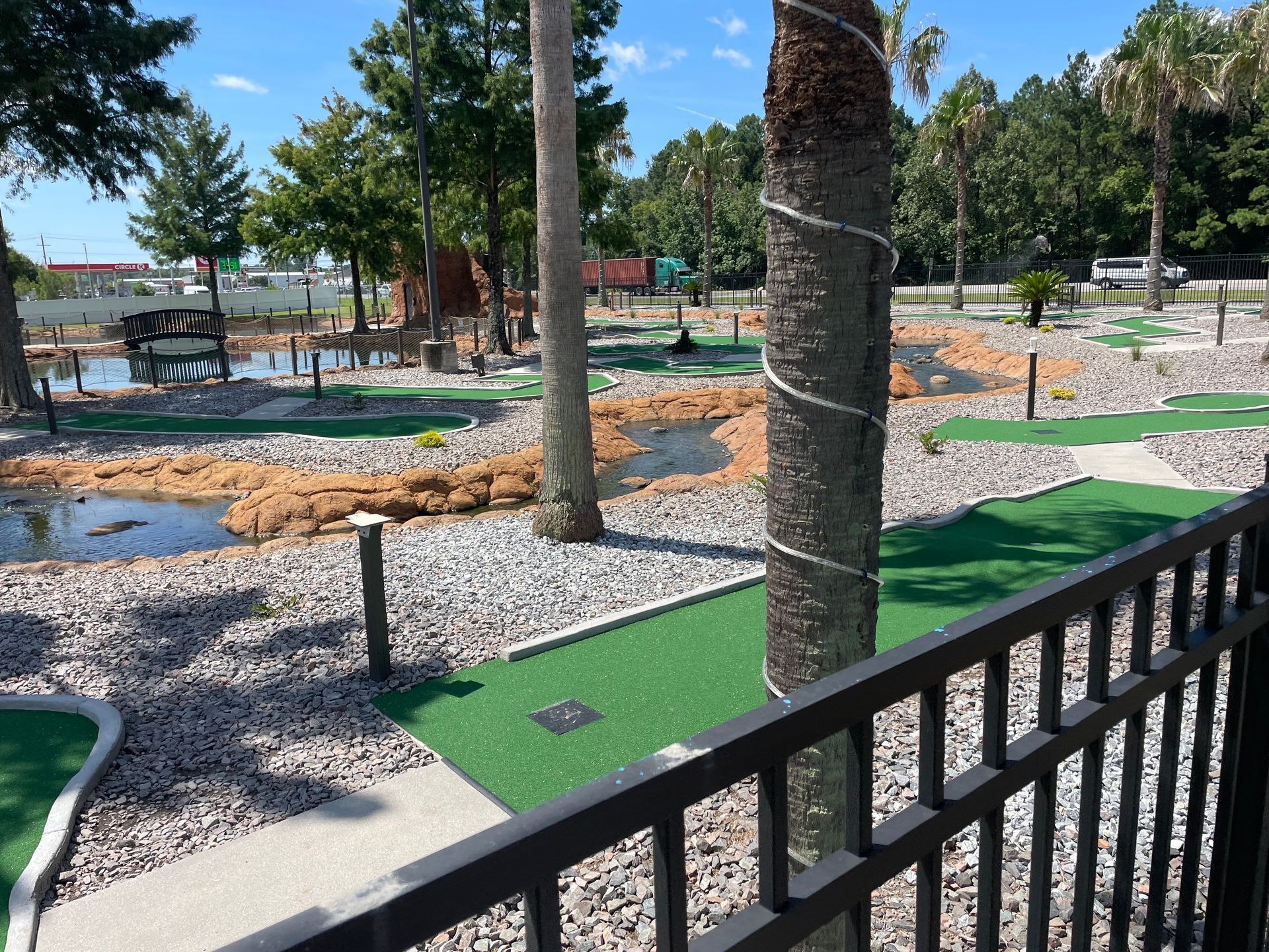 A view of a mini golf course from a balcony