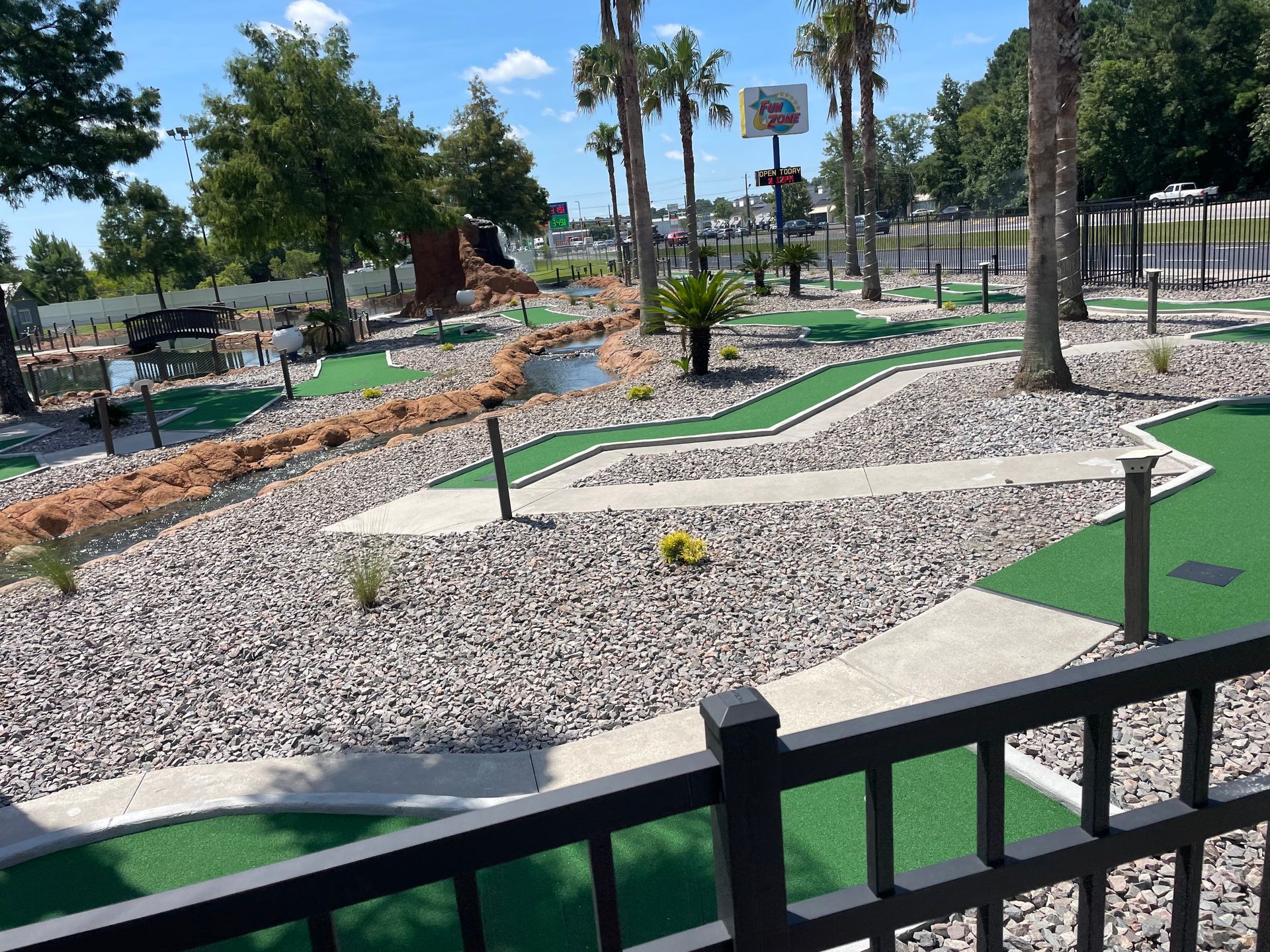 A view of a mini golf course from a balcony.