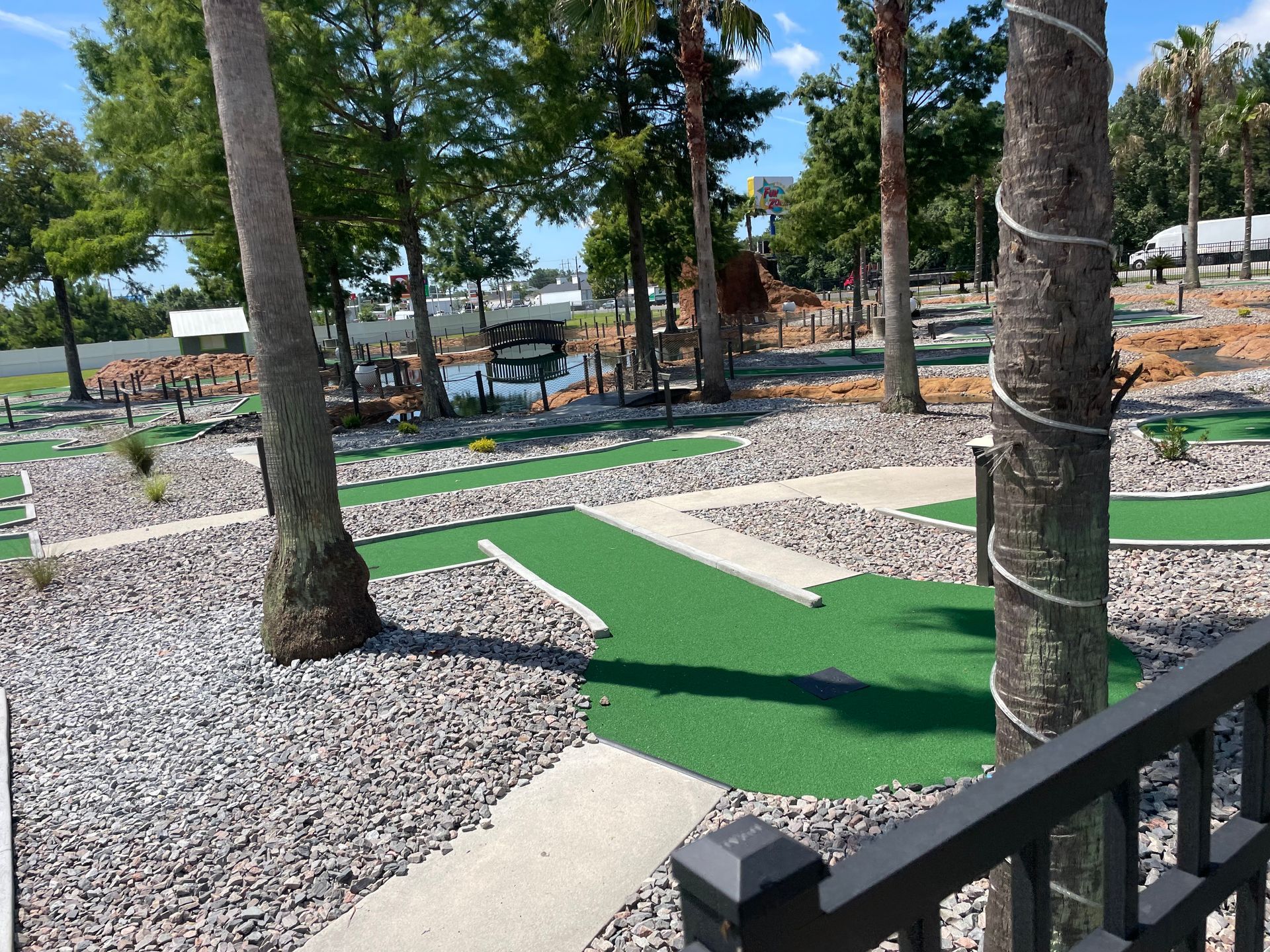 A view of a mini golf course from a fence