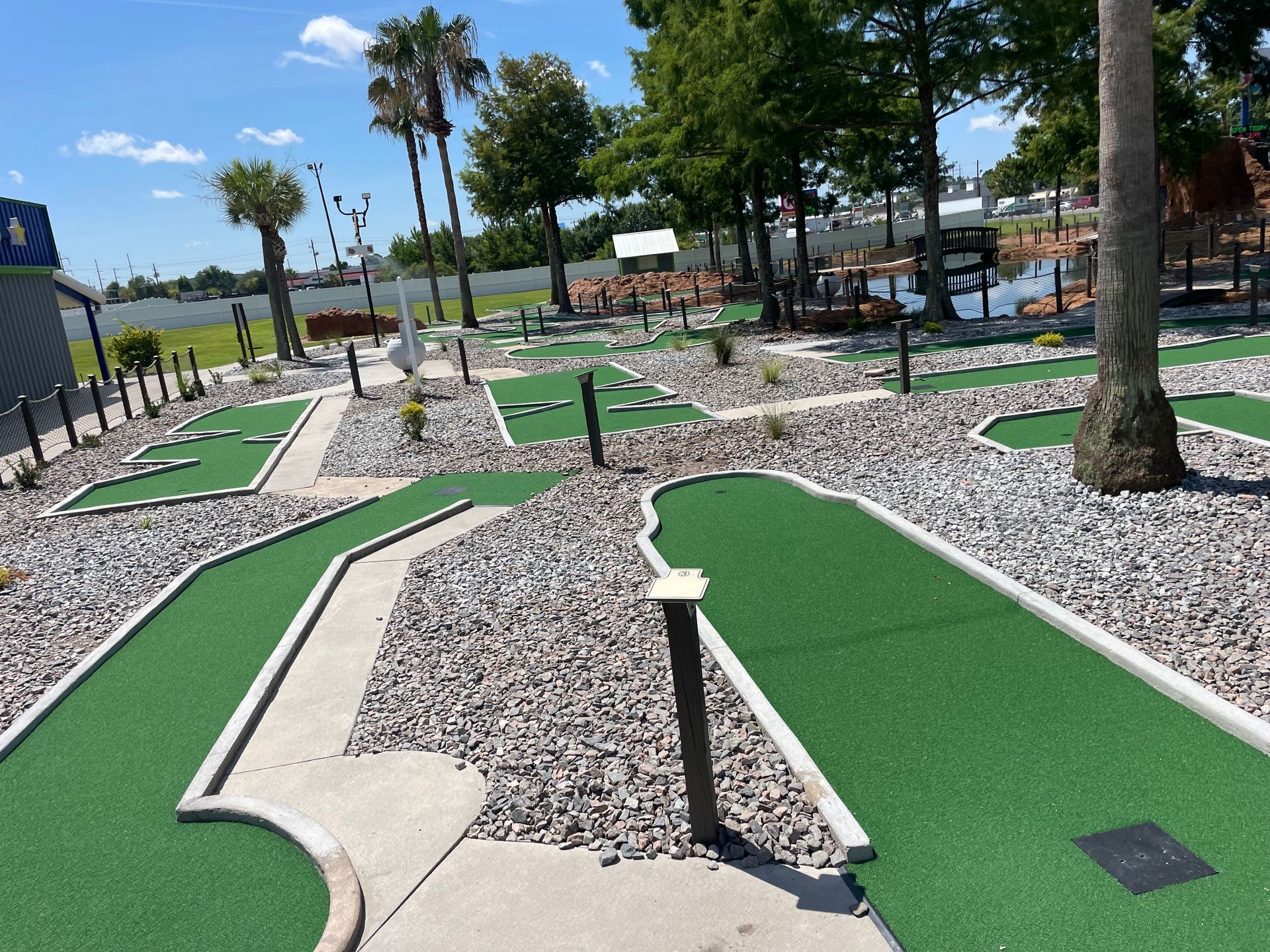 A miniature golf course with trees in the background