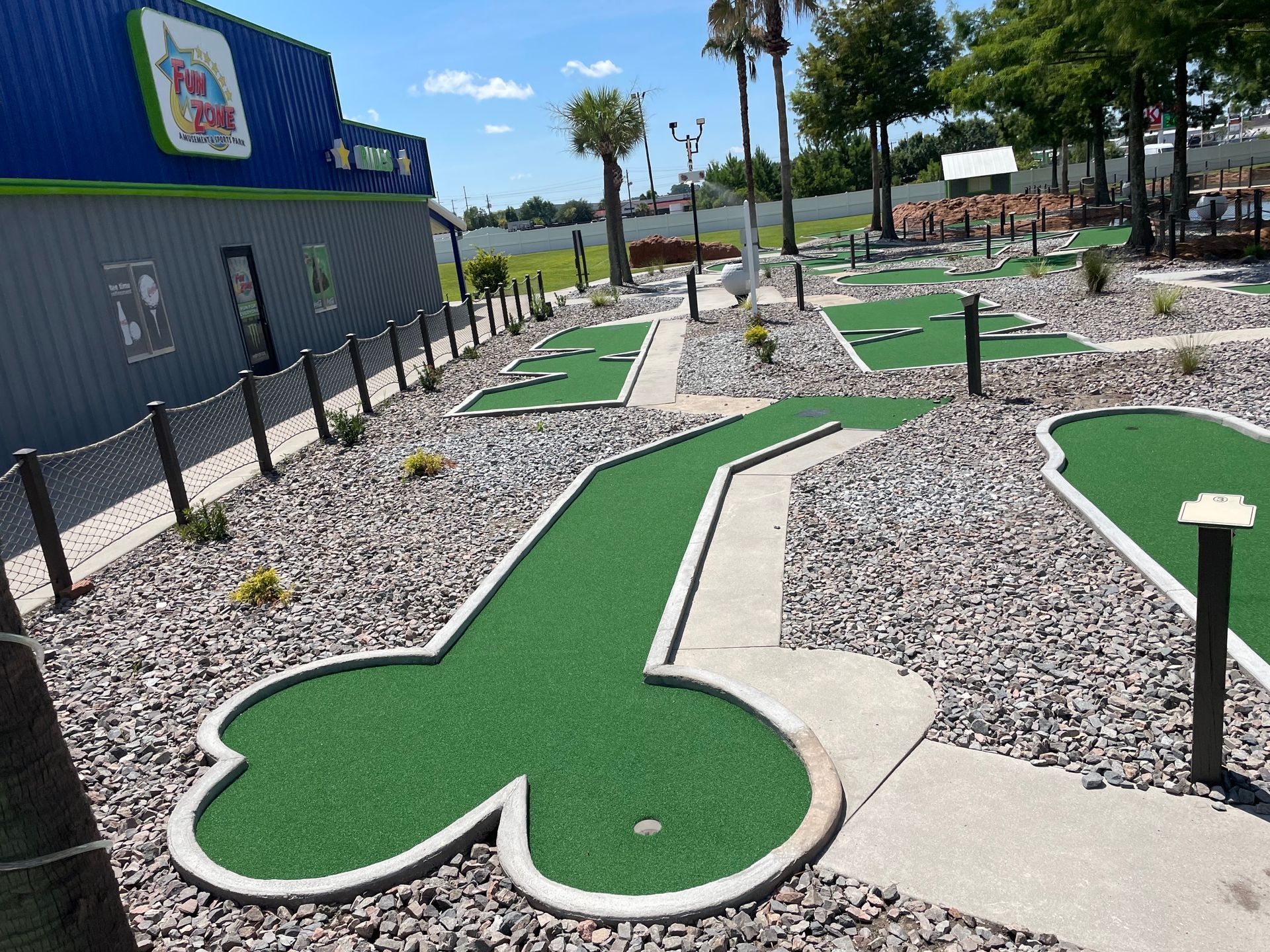 A mini golf course with a building in the background