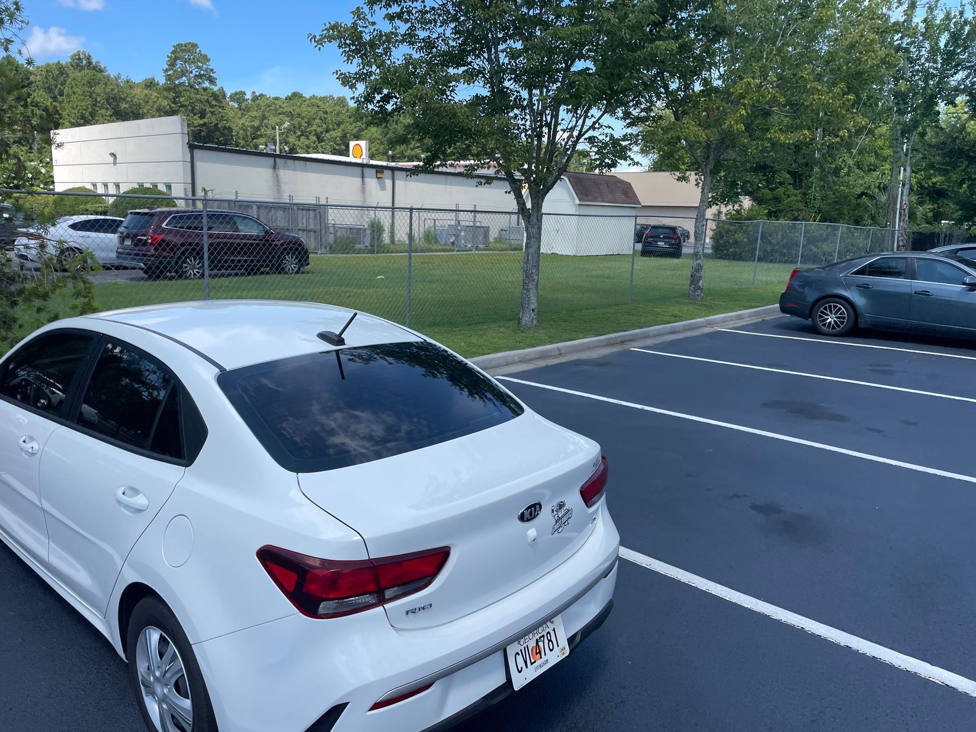 A white car is parked in a parking lot.