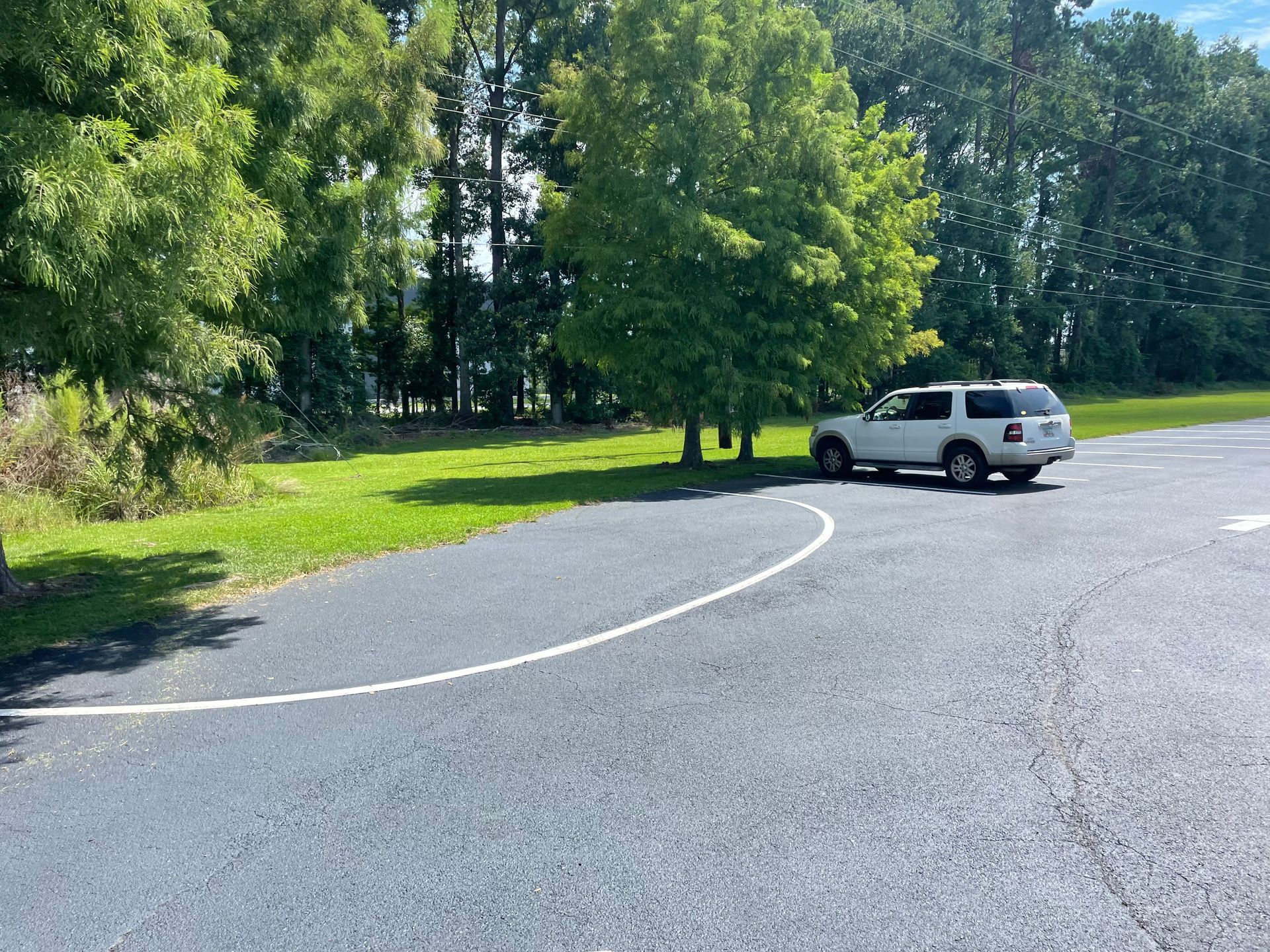 A white suv is parked on the side of the road