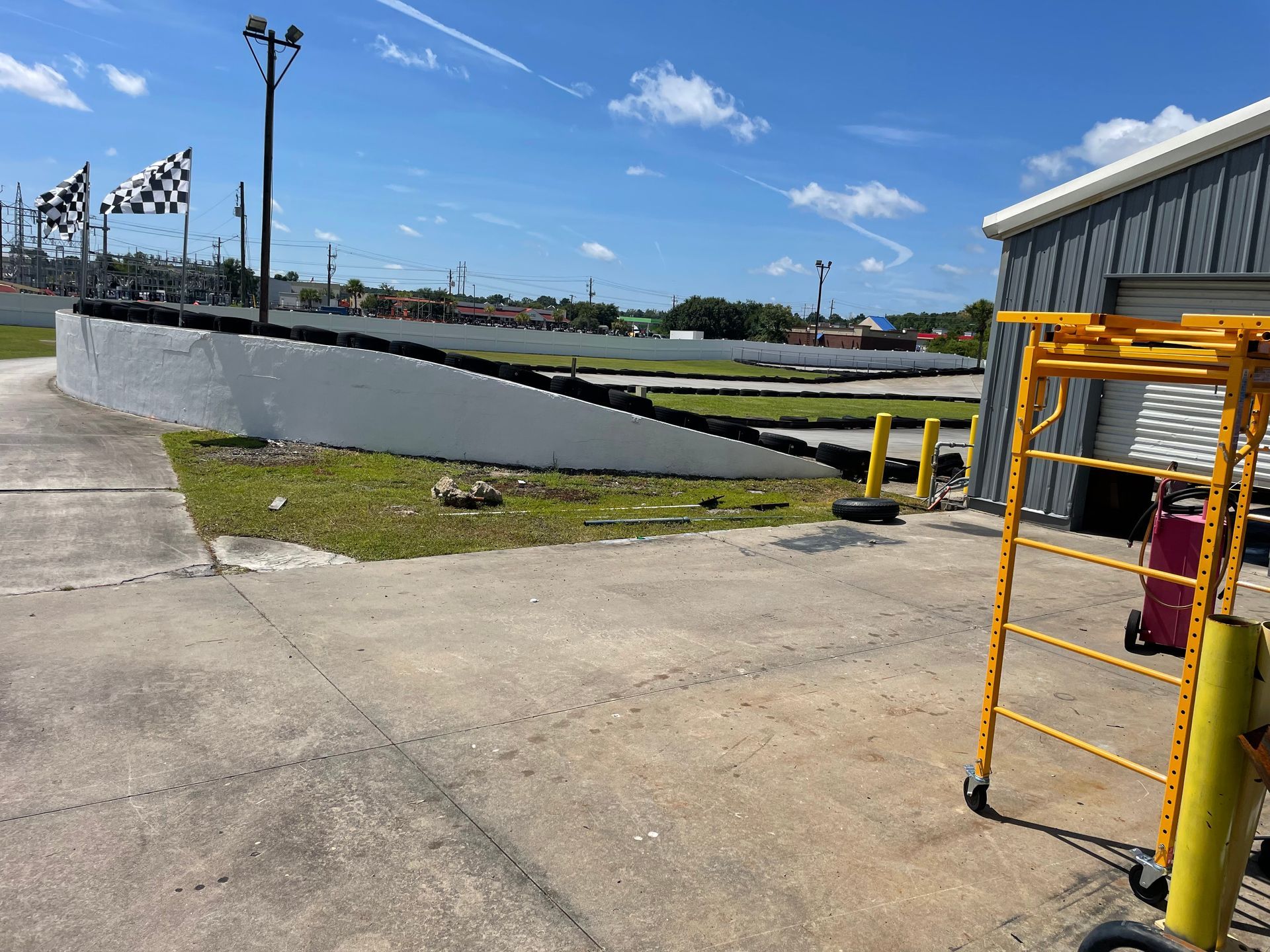 A yellow scaffolding is sitting in front of a race track.