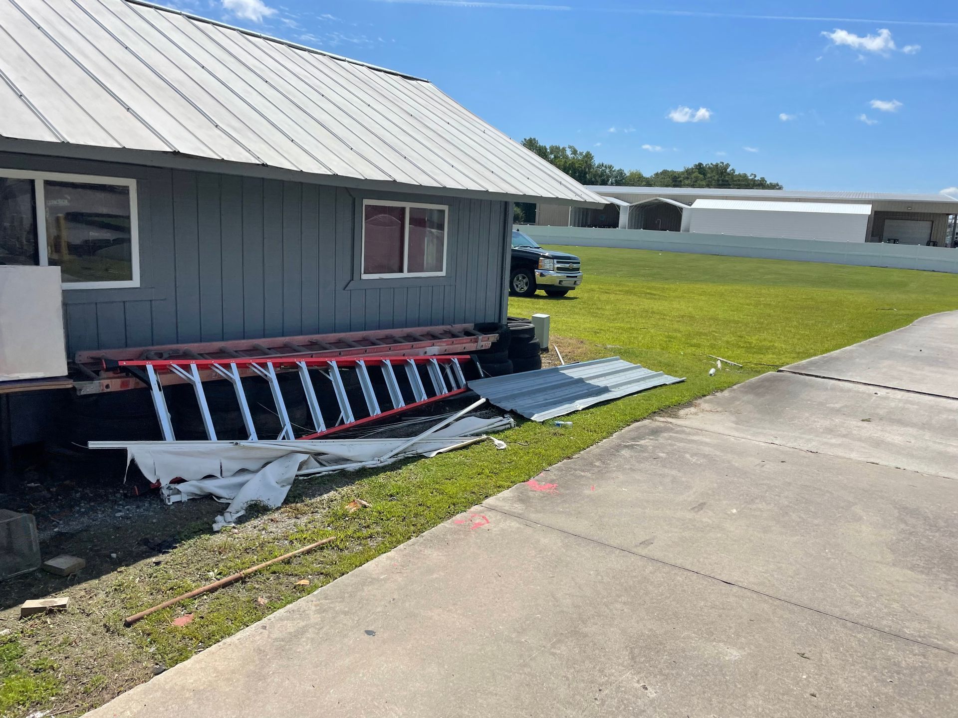 A ladder is sitting in front of a small house.