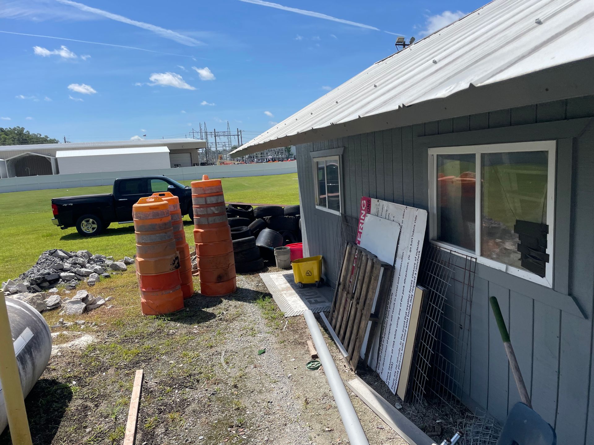 A gray building with a truck parked in front of it.