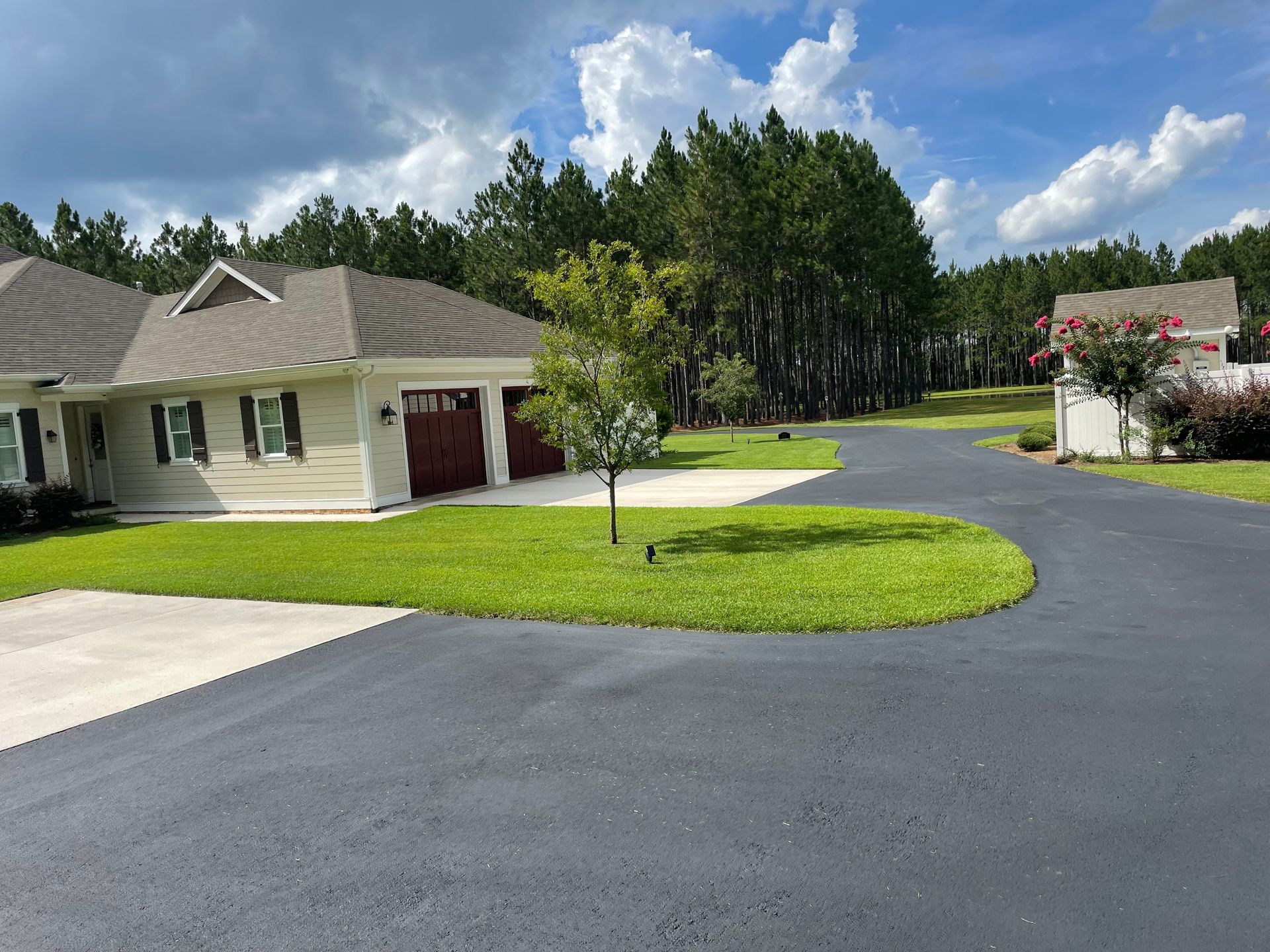 A house with a large driveway leading to it