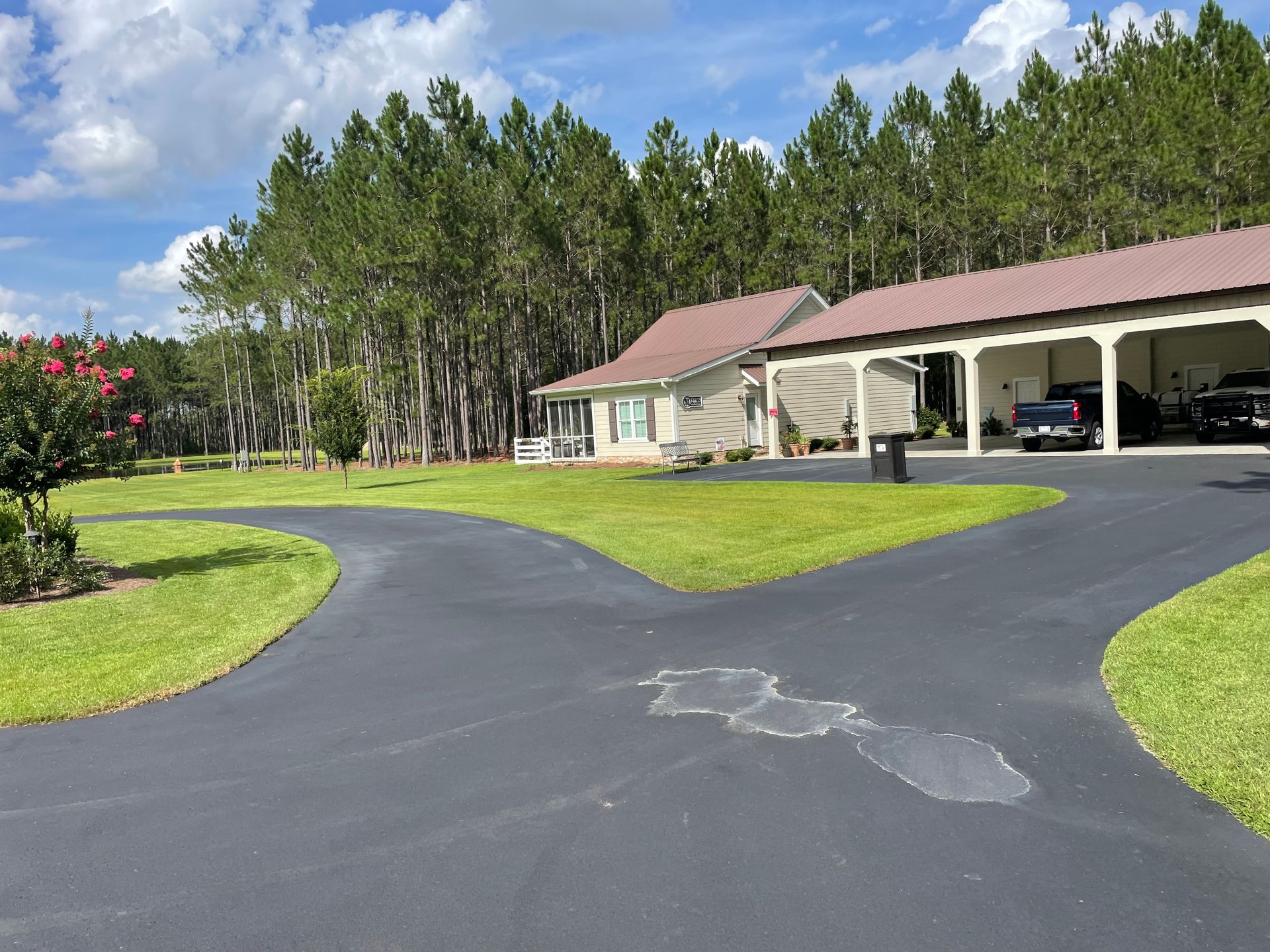 A driveway leading to a house with a covered garage
