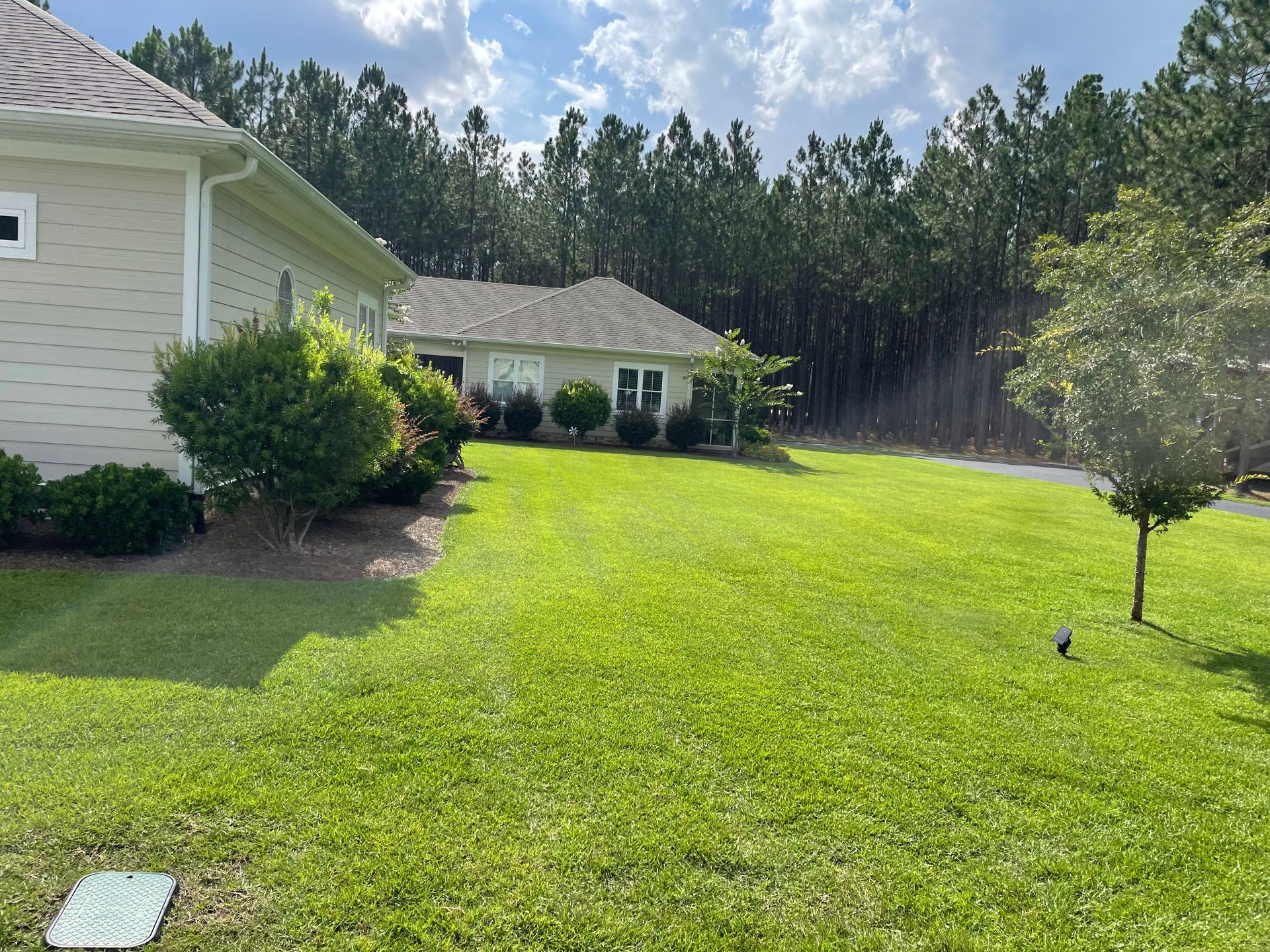A house with a large lawn in front of it