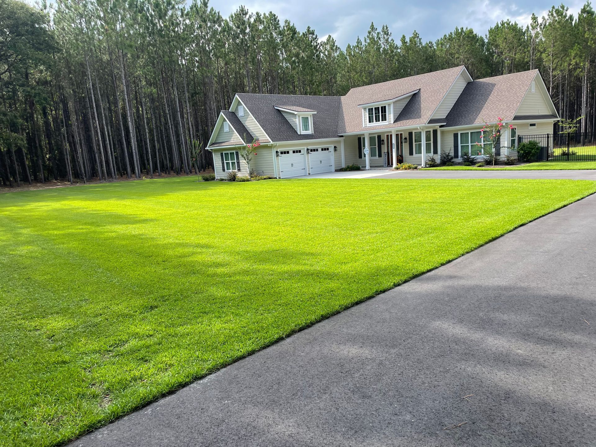 A large house with a lush green lawn in front of it