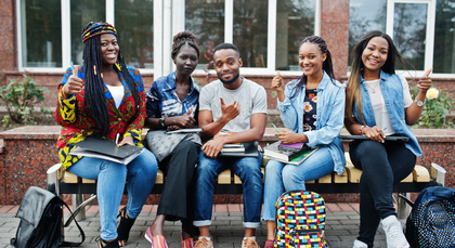 A group of young people are sitting on a bench.