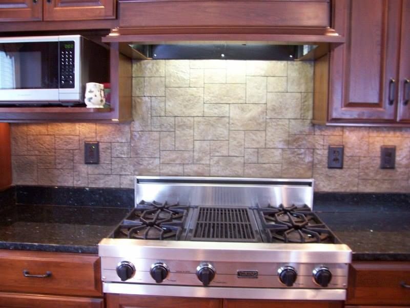 Kitchen with stainless steel range, brown cabinets, and textured backsplash.