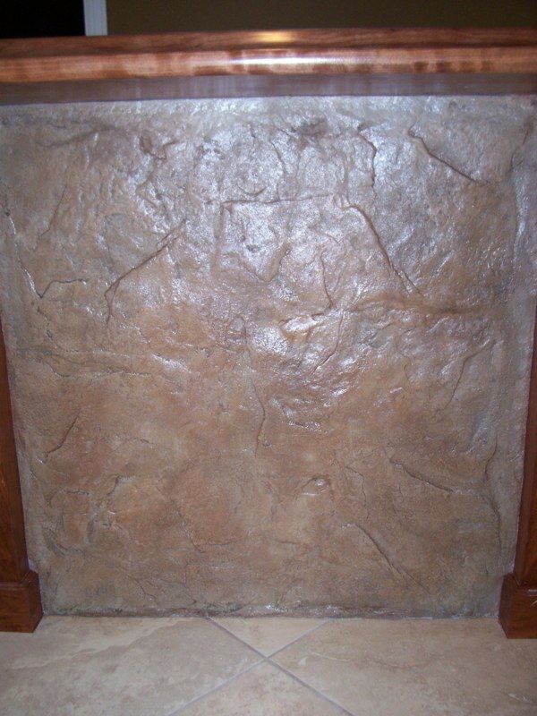 Stone textured wall with wooden trim.