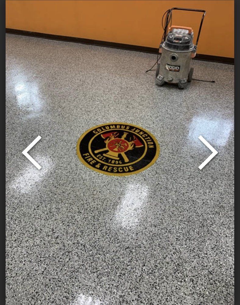 Floor with Columbia Station Fire & Rescue emblem; shop vacuum in background.