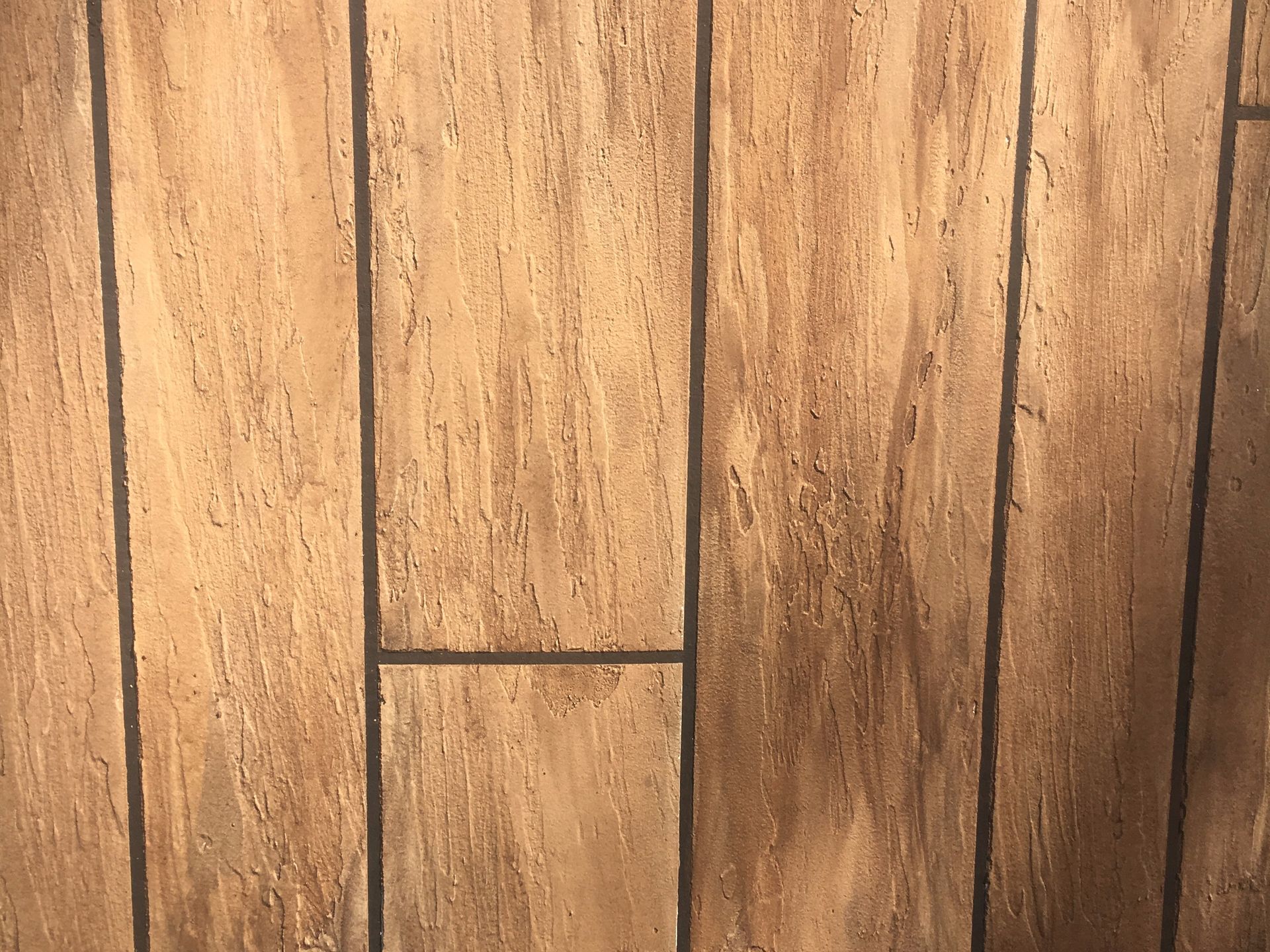 Wood flooring with dark lines between planks.