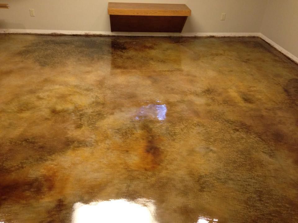 Metallic epoxy floor with brown and gold swirls, reflecting ambient light.