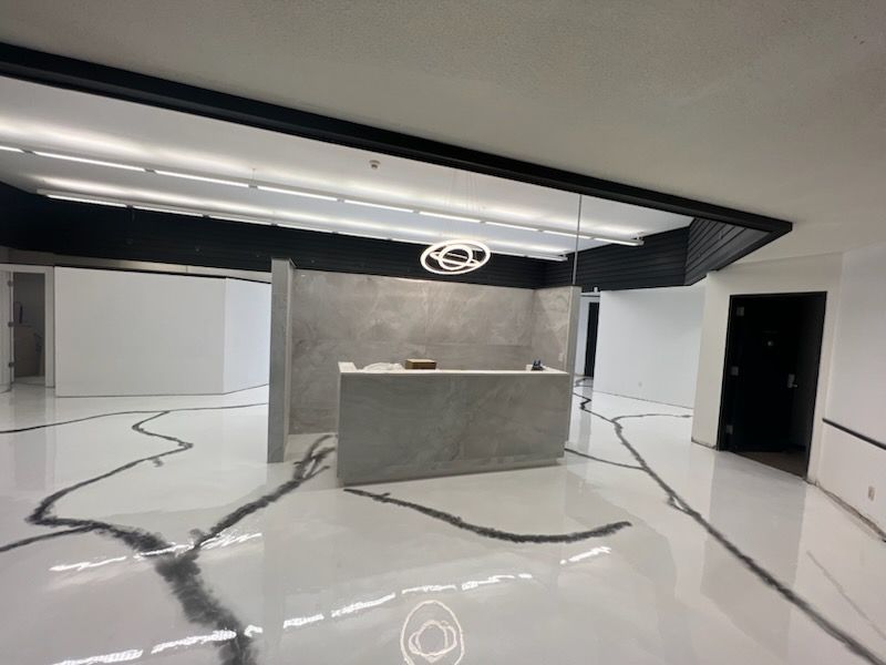 Fireplace with stone surround, black firebox, and wooden mantel; beige and brown tones.