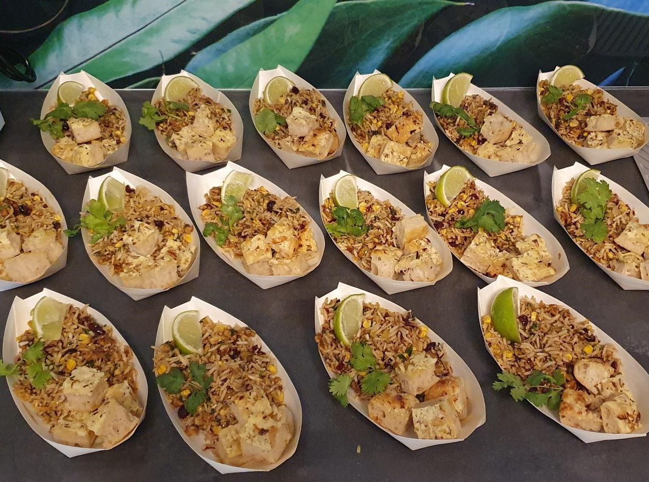 A bunch of small boats filled with food on a table