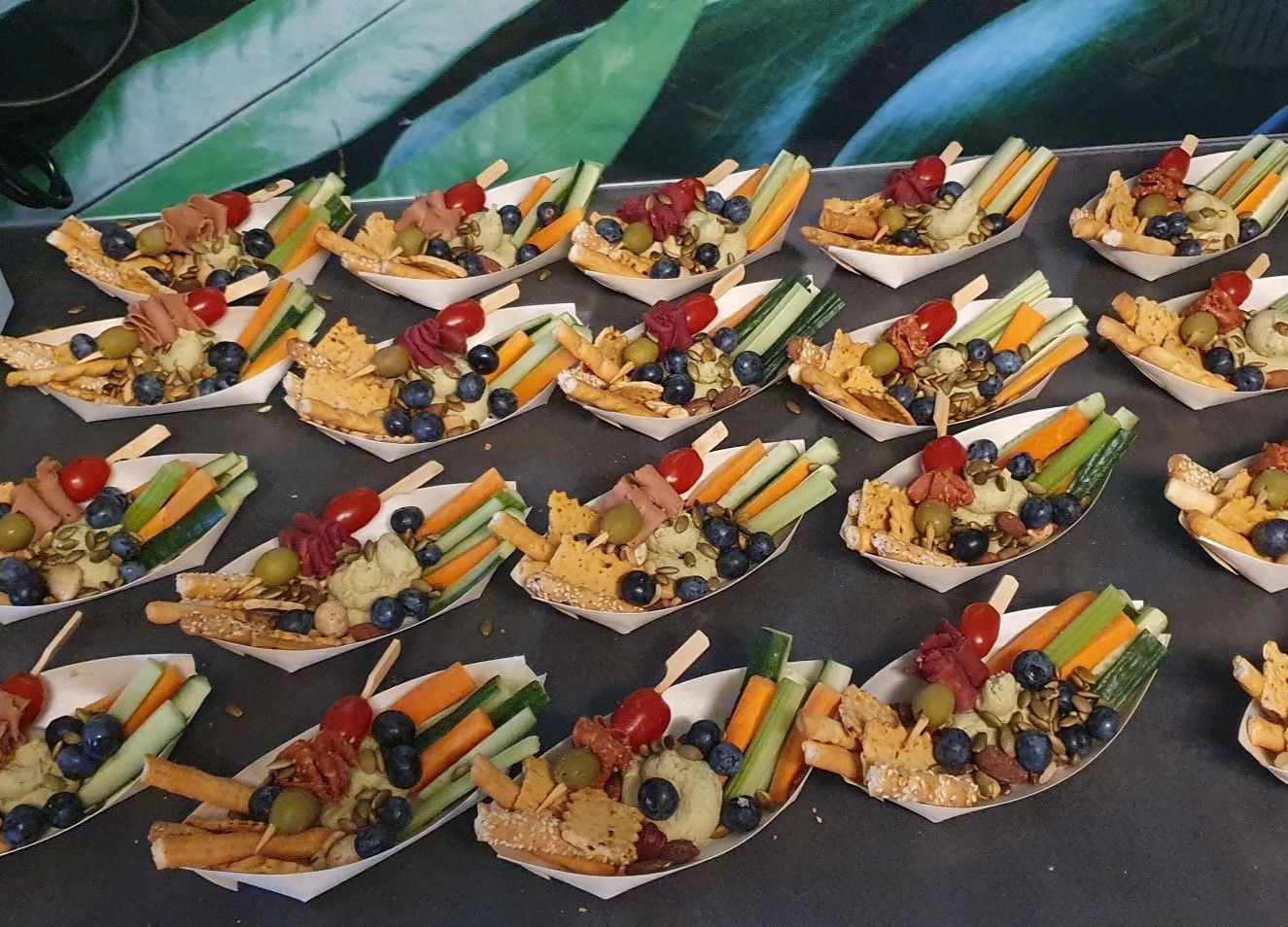 A bunch of plates of food with vegetables and fruit on them