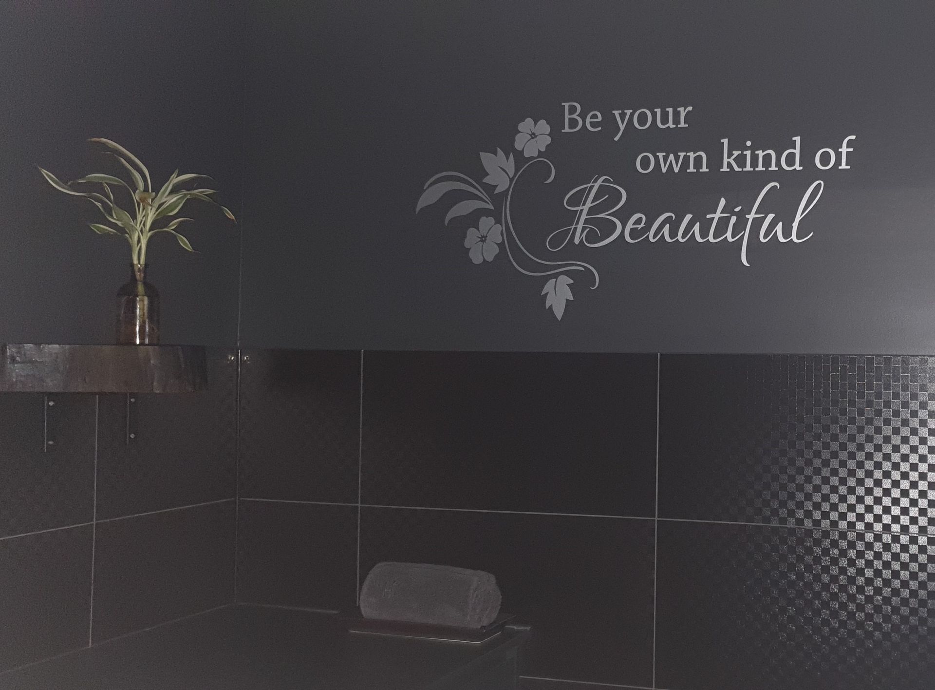 A bathroom wall with a sticker that says be your own kind of beautiful