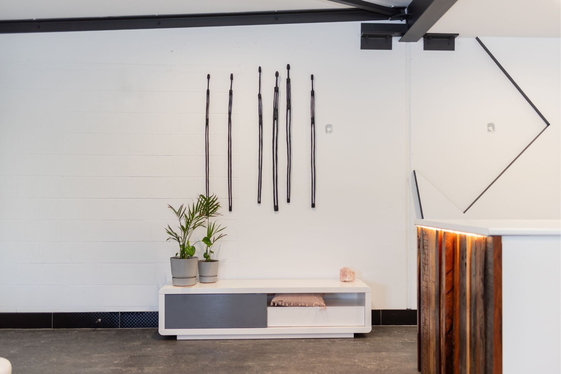 A room with a white wall and a wooden counter