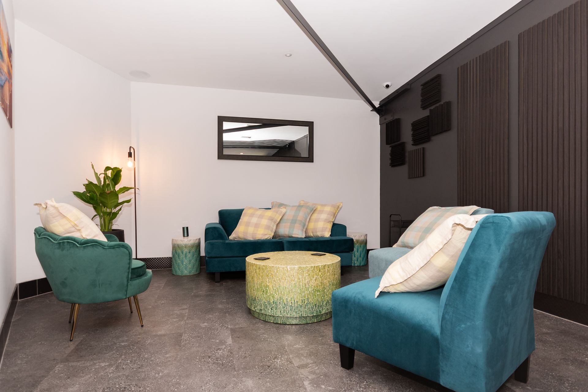 A living room with a couch , chairs , and a coffee table.