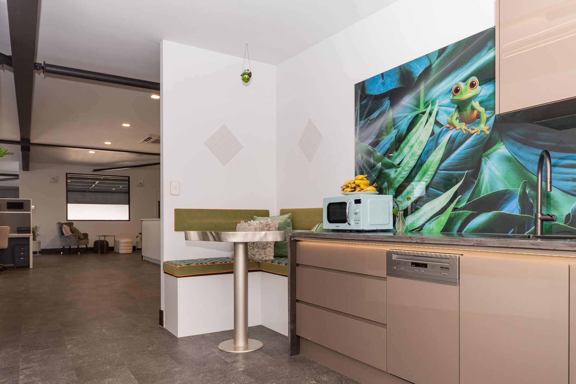 A kitchen with a picture of a frog on the wall
