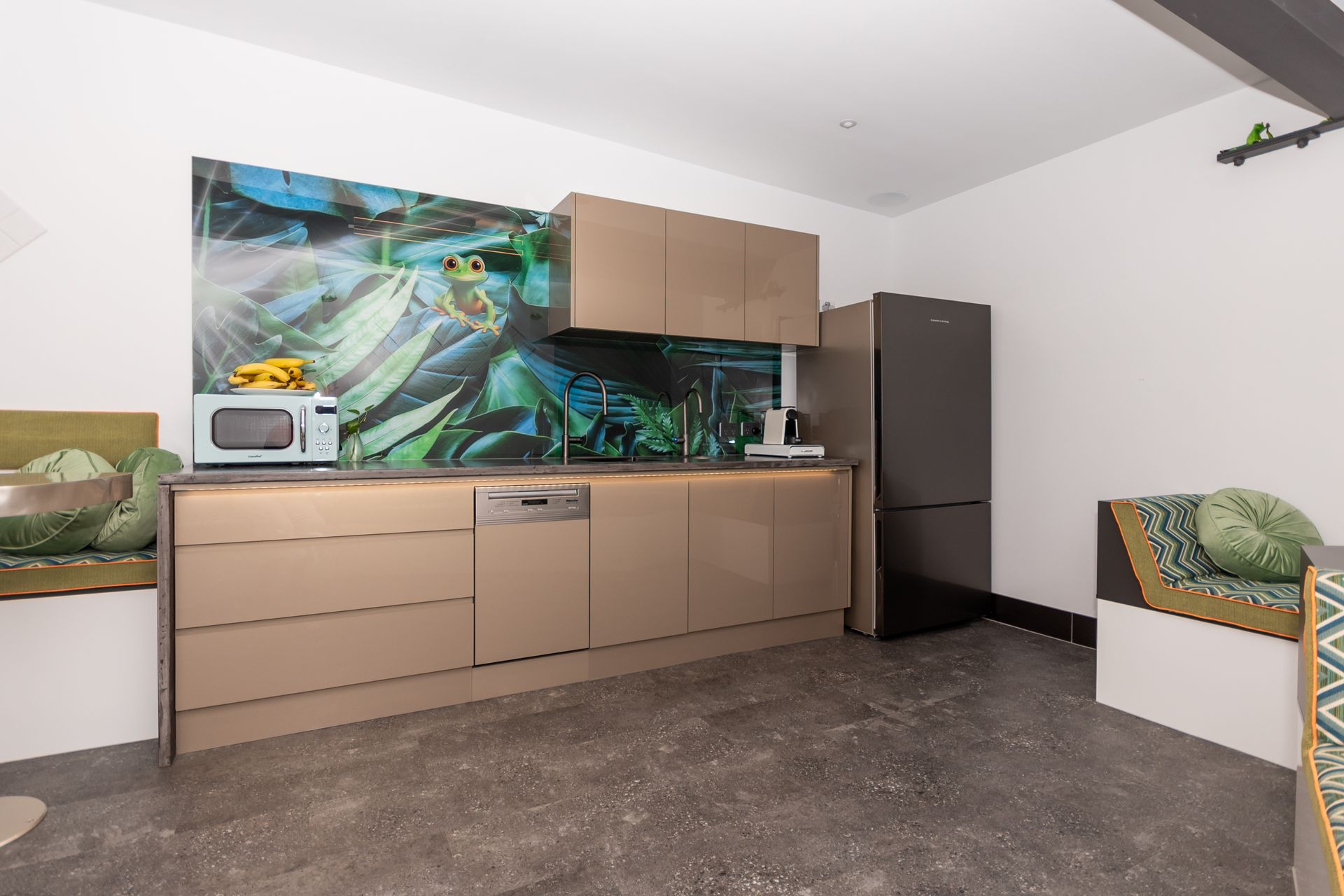 A kitchen with a picture of a frog on the wall