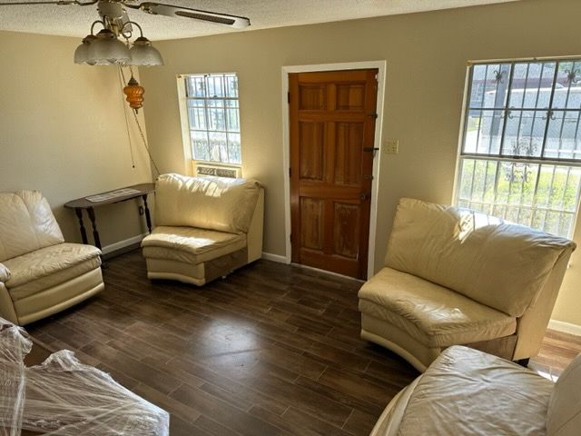 A living room filled with furniture and a ceiling fan.