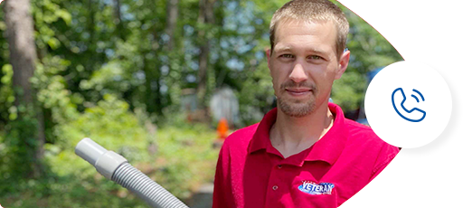 A man in a red shirt holding a vacuum hose outside, with a phone icon in a white circle.
