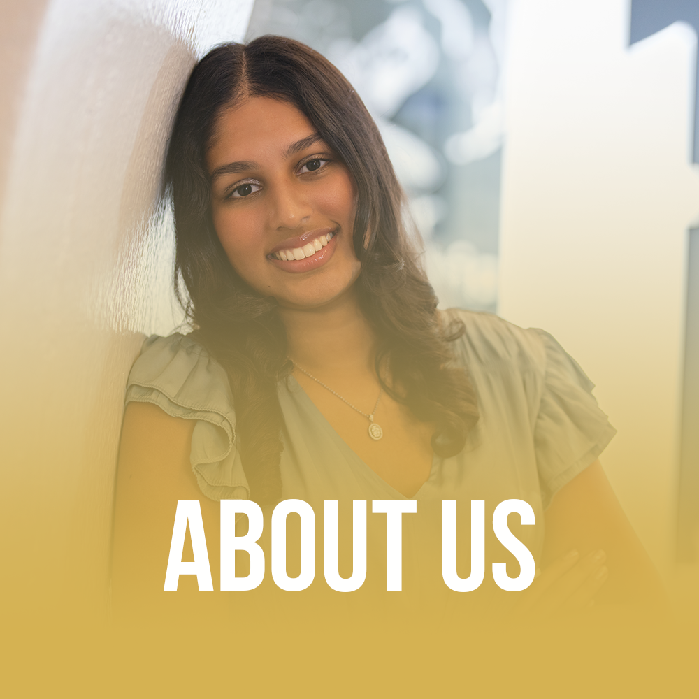 Young woman leaning on a wall, smiling.