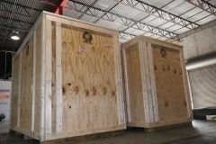 Two large wooden crates side-by-side in an industrial setting.