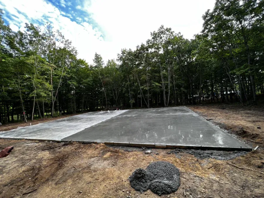 A concrete floor is being built in the middle of a forest.