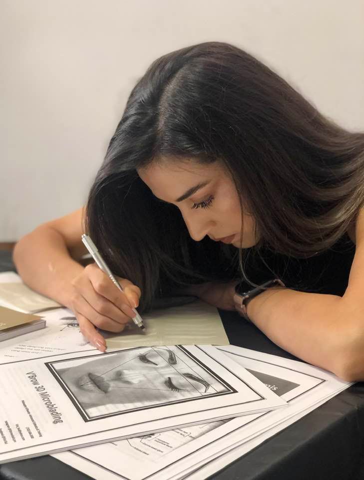 Person holding a laser hair removal device in a brightly lit room.