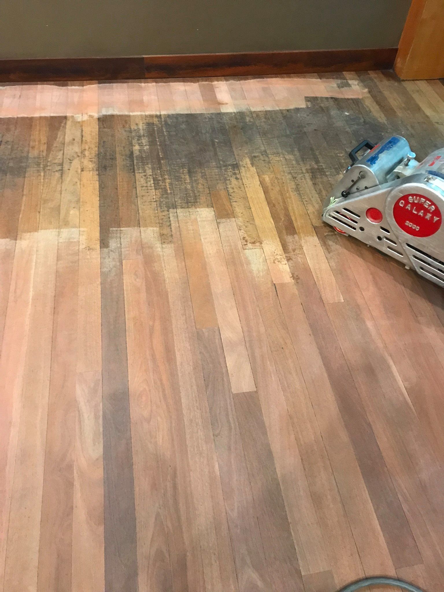 Wooden Floor Being Sanded With a Machine — Custom Floor Sanding In Gosford, NSW