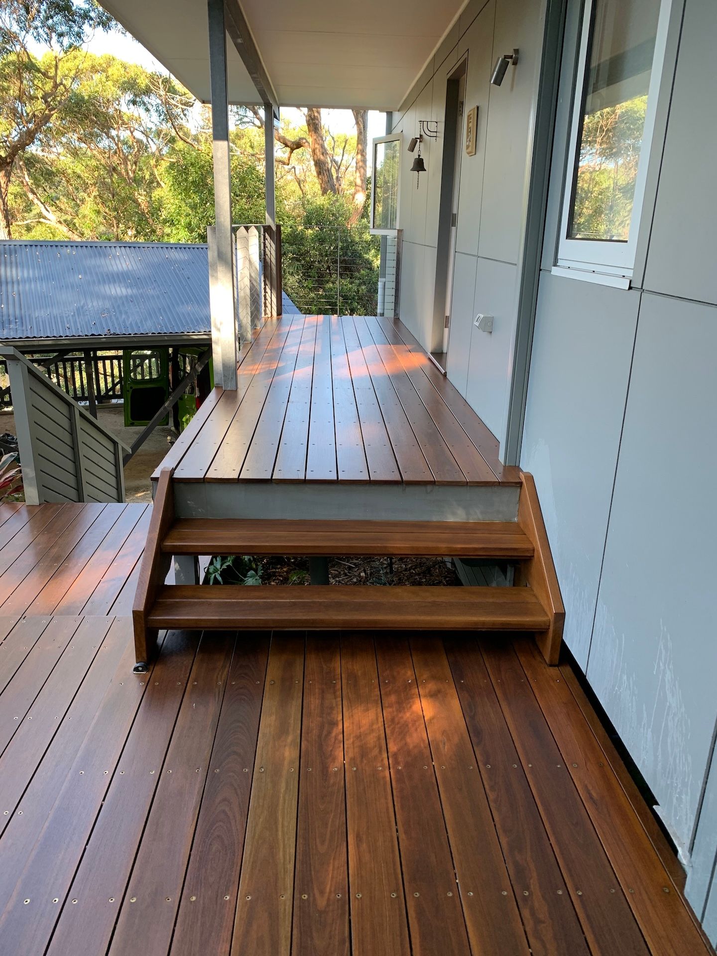 Wooden deck with steps leading to a front porch — Custom Floor Sanding In Somersby, NSW