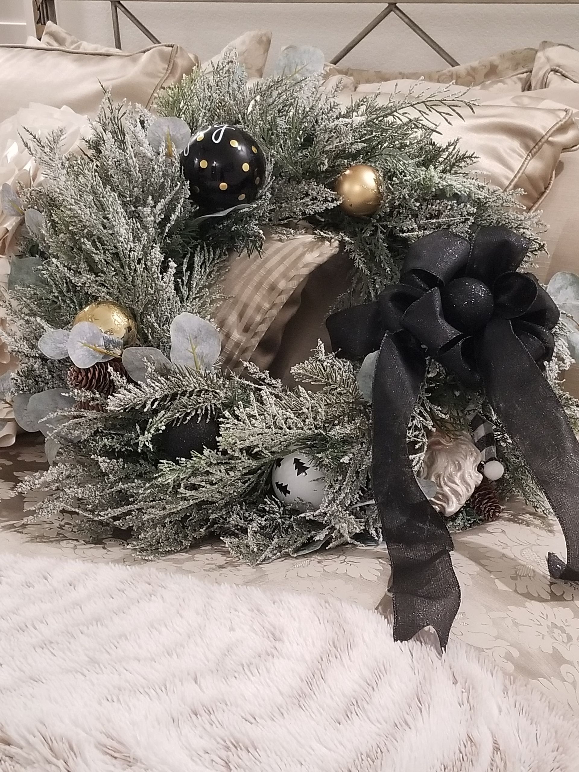 A Christmas wreath with a black bow.