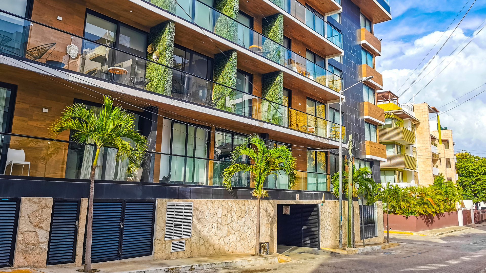 Person in protective wear power-washing a wooden floor.